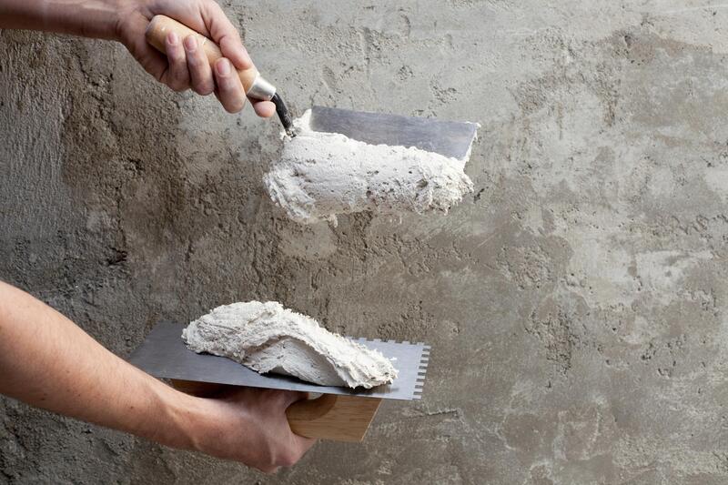 mixing the cement to the wall